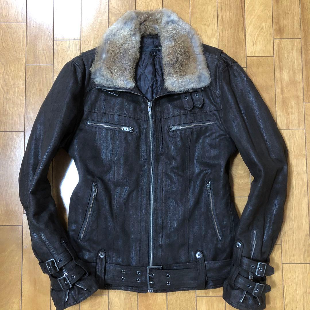 Front view of a brown faux-suede men's rider jacket with a faux-fur collar laid flat on a wooden floor.