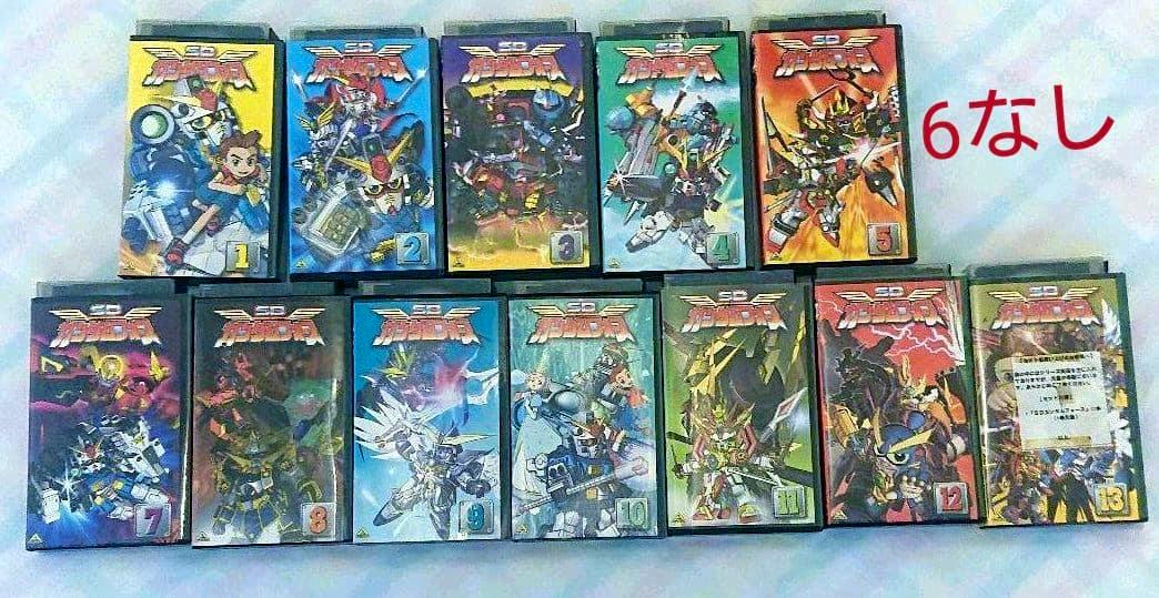 Front covers of SDガンダムフォース VHS tape cases arranged in two rows showing numbered volumes.