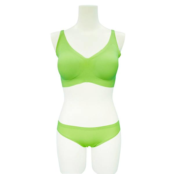 Pistachio green seamless bra and matching shorts displayed on a white torso mannequin.