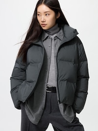 Female model wearing the women's seamless down short jacket against a plain white background.