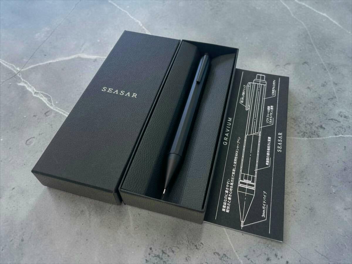 Black SEASAR GRAVIUM mechanical pencil displayed in its black presentation box with the lid and product schematic card visible.