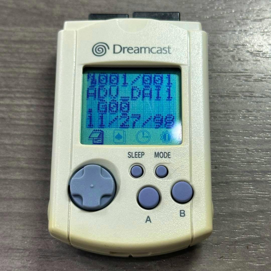 Front of the Dreamcast Visual Memory (HKT-7000) showing the LCD screen, D-pad, and A/B buttons.