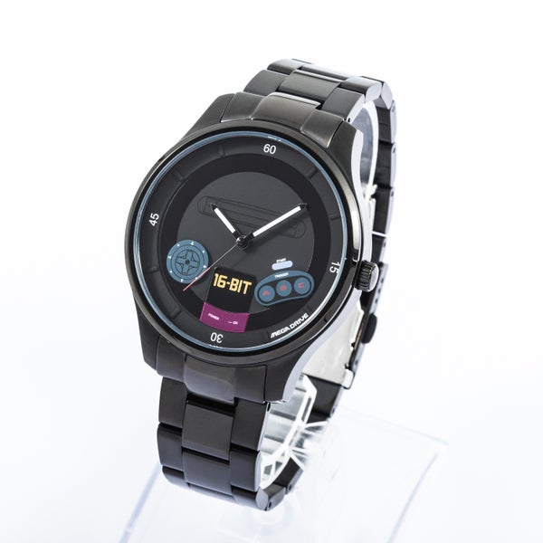 Black metal-case wristwatch with a metal link bracelet and a Mega Drive–style dial showing "16-BIT" text and gaming-themed icons.