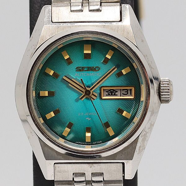 Close-up front view of a Seiko 2206-0520 ladies automatic wristwatch with a textured green dial and day–date window.