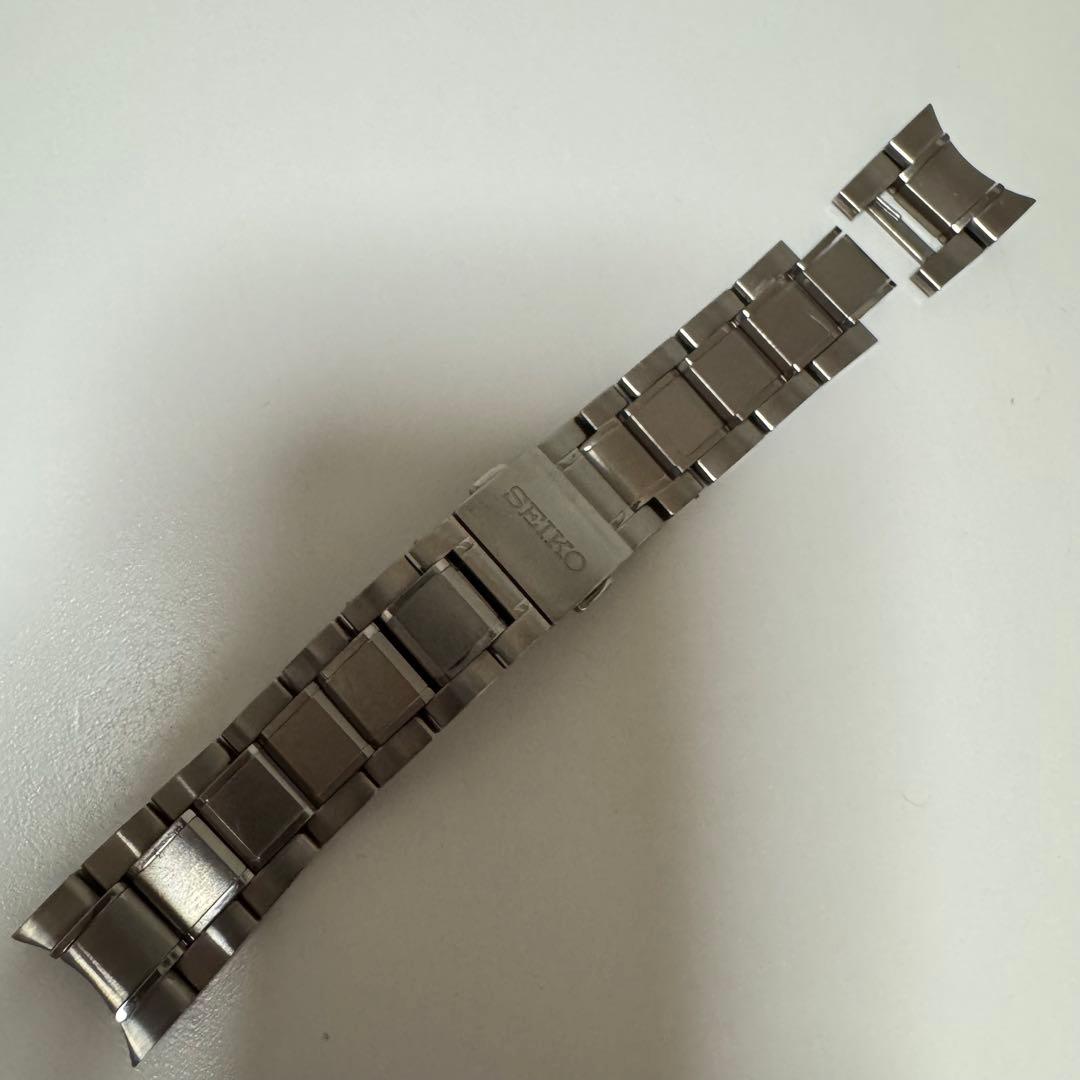 Metal Seiko BRIGHTZ watch strap/bracelet with clasp laid on a white background.