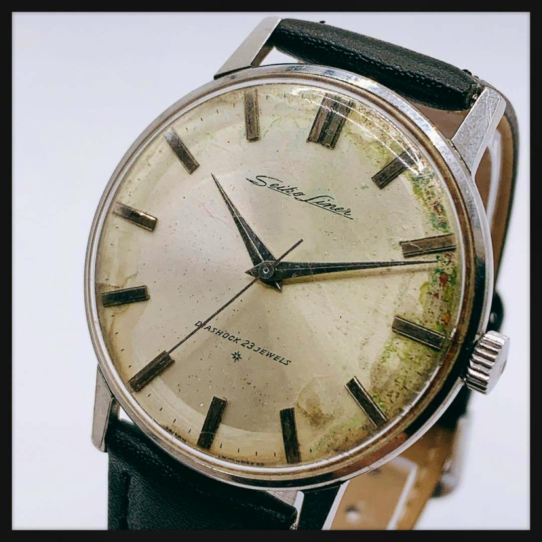 Close-up of a vintage Seiko Liner automatic men's wristwatch showing the dial, hands, hour markers, crown, and black leather strap.