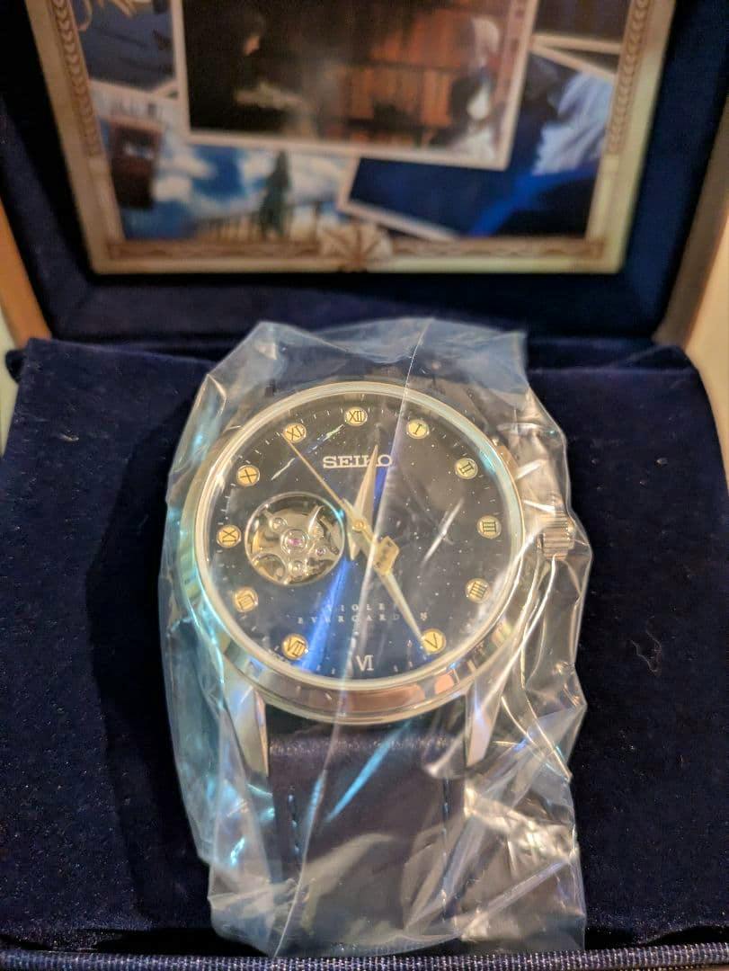 Close-up of the SEIKO Violet Evergarden collaboration wristwatch in its presentation box with protective plastic over the watch face.