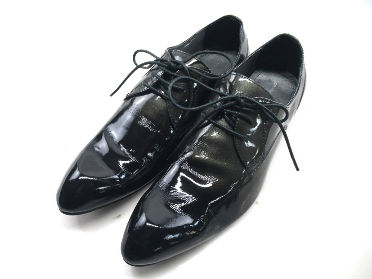 Pair of black patent leather men's business shoes with laces on a white background.