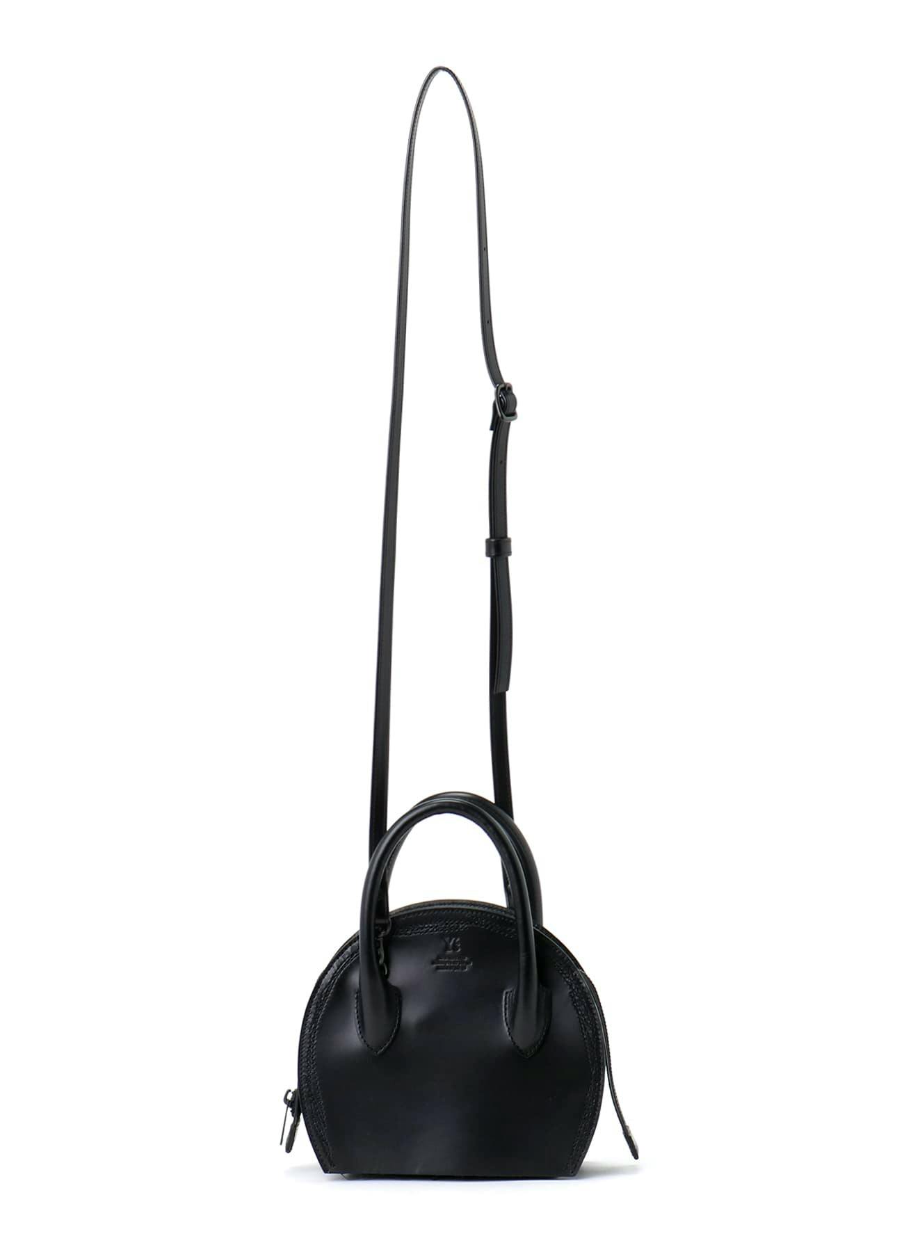 Front view of a black semi-gloss round leather bag with top handles and a long shoulder strap.