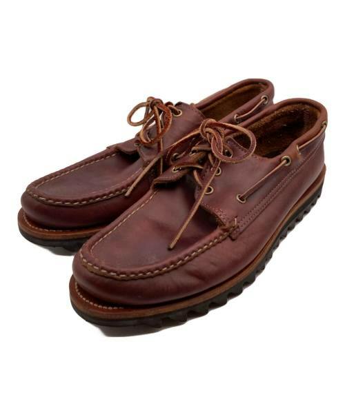 Pair of brown leather moccasin shoes with shark soles shown at an angled top-side view.