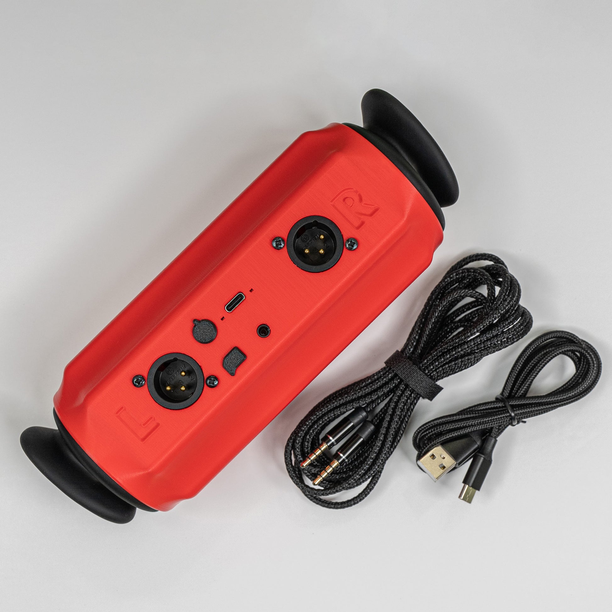 A red Seraph Pro binaural microphone showing two XLR connectors and two included cables on a white background.