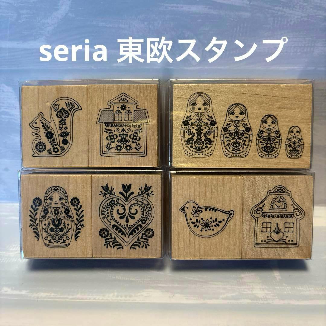 Wooden stamp blocks showing Eastern European matryoshka and folk motifs arranged in rows.