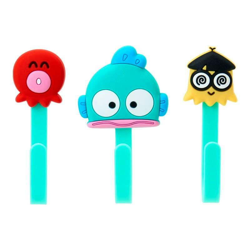 Three decorative hooks with cartoon character tops shown on a white background.