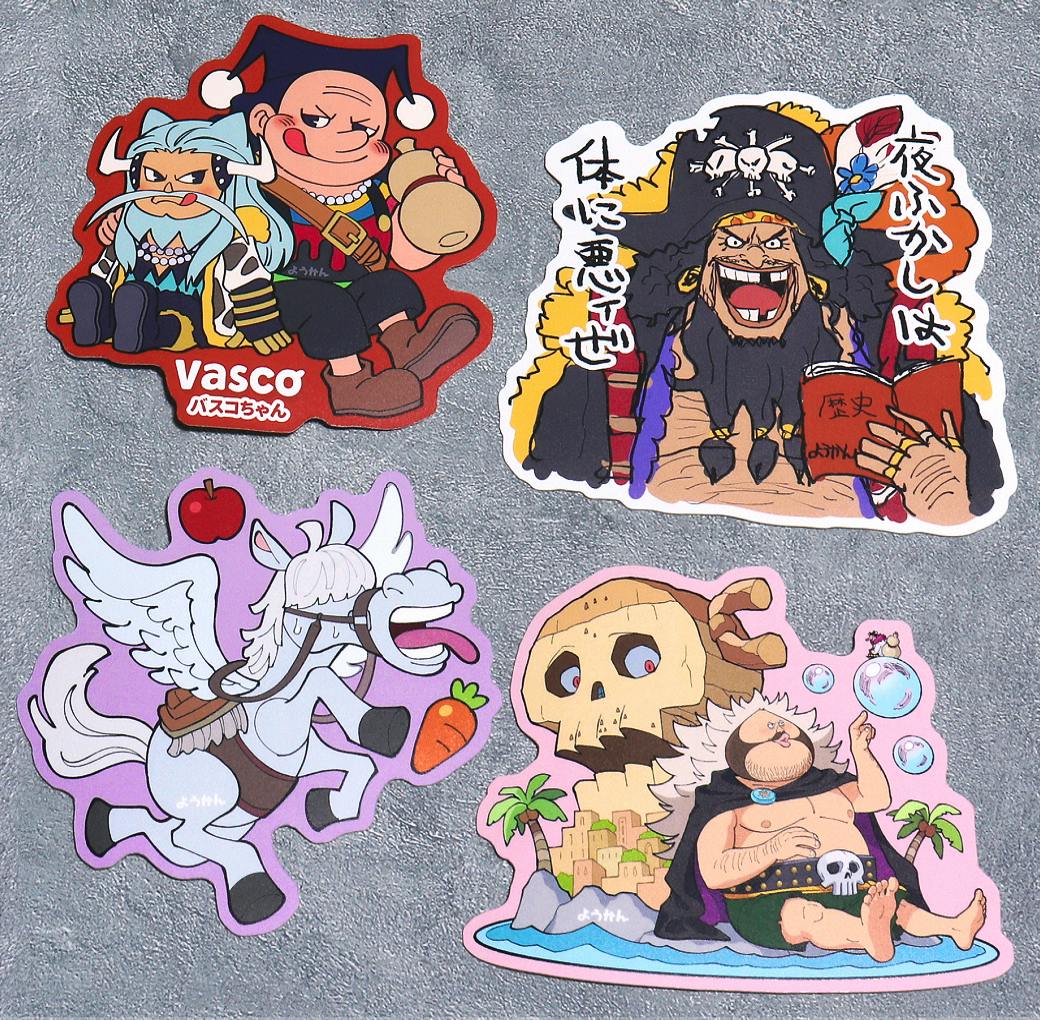 Photograph of the four deformed (chibi) sticker designs from the set arranged on a gray textured surface.