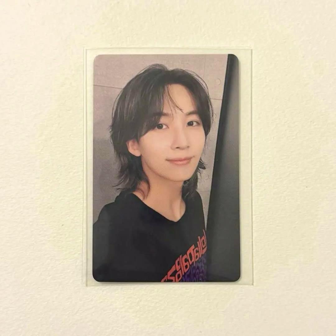 Photocard front side showing a portrait of a man wearing a black shirt against a light background.