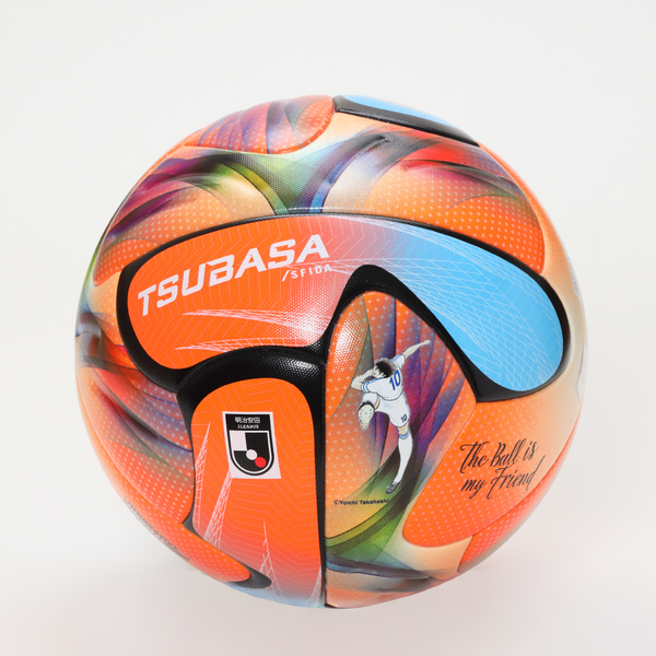 An orange TSUBASA soccer ball with multicolored graphic panels and visible TSUBASA branding.