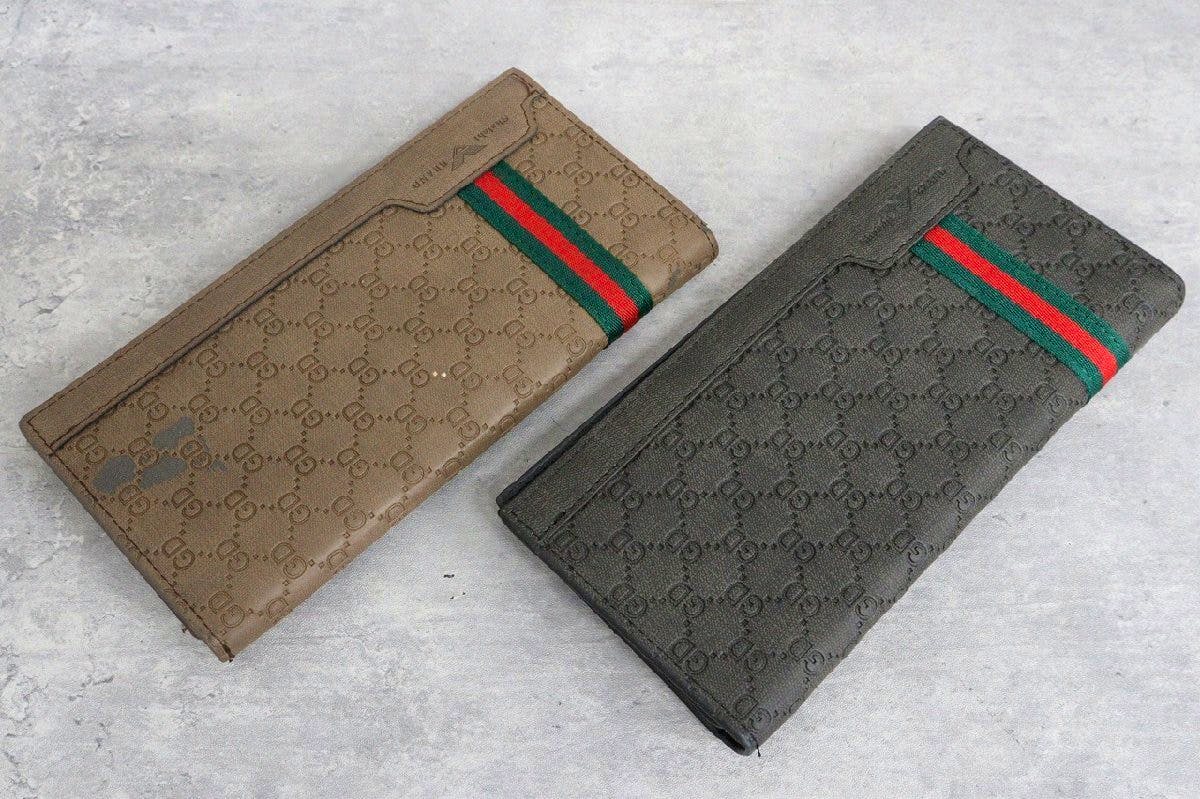 Two long wallets (beige and gray) with an embossed repeating pattern and a green-red fabric stripe, shown closed on a light gray surface.