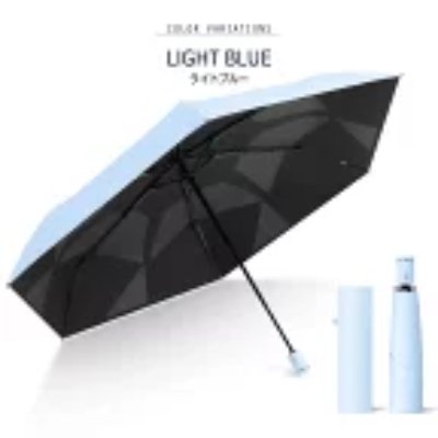 Light blue folding umbrella shown open with a black inner canopy and a matching storage sleeve and folded umbrella beside it.
