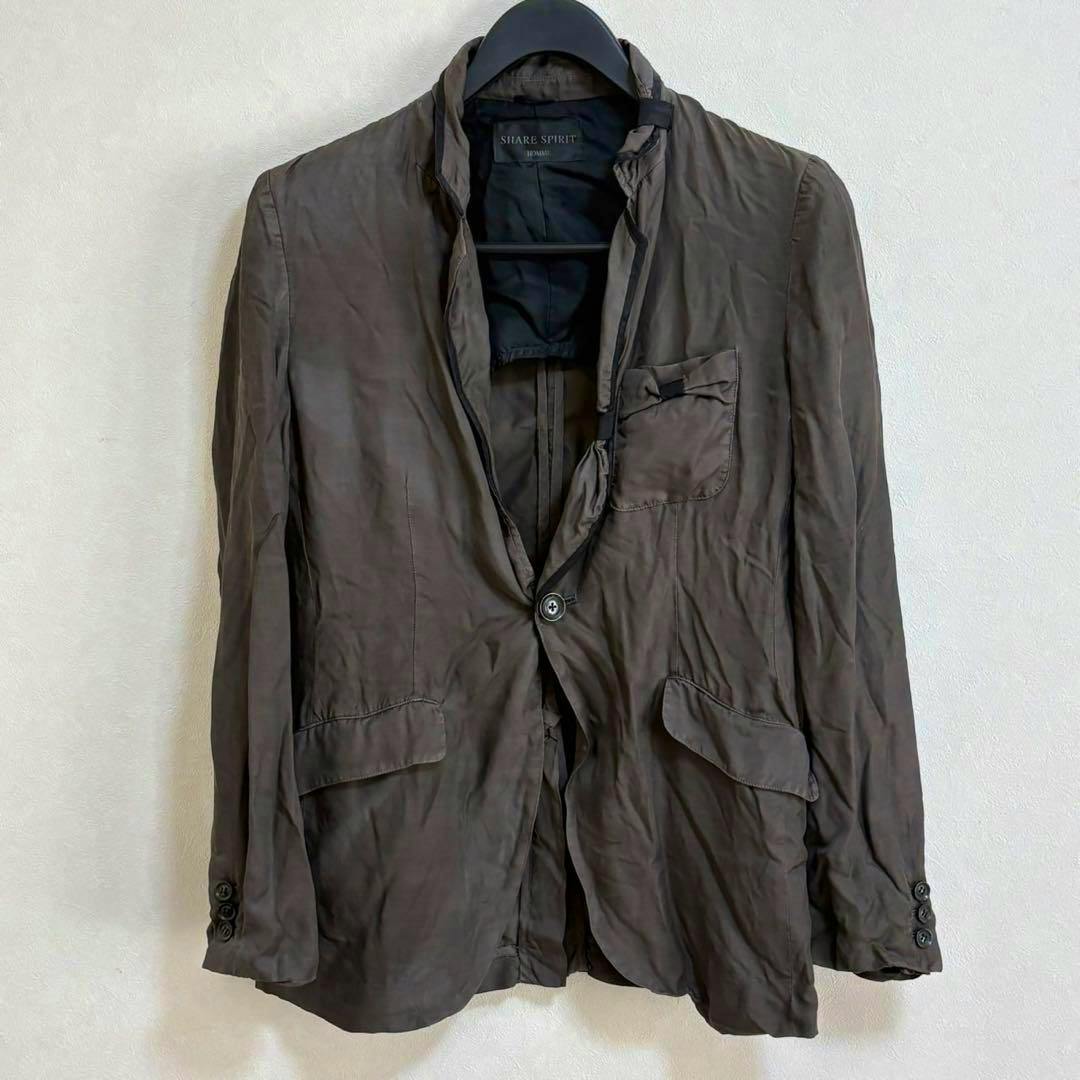 Front view of a SHARE SPIRIT HOMME men's cotton jacket hanging on a hanger against a plain wall.