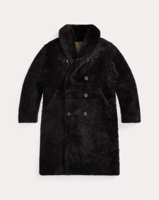Black shearing (mouton) long jacket shown laid flat on a pale background.