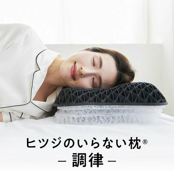 A woman resting her head on the pillow with a black honeycomb top and a clear mesh base.