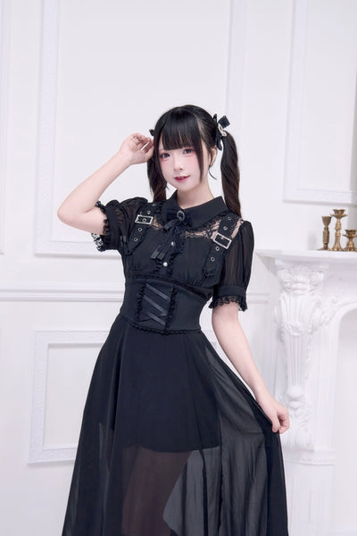 A model wearing the black sheer corset long dress with short puff sleeves and a fitted corset waist.