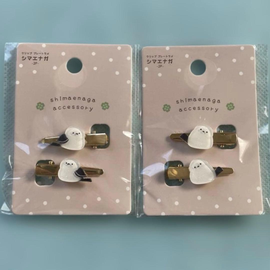 Two packages each showing shimaenaga bird hair clips on pink polka-dot backing cards.