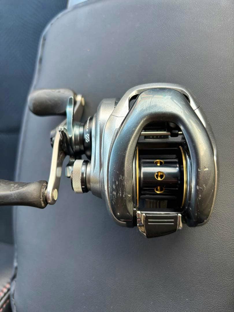 Front view of the SHIMANO 13Metanium HG left-handle baitcasting reel showing the spool, handle, and surface scratches.