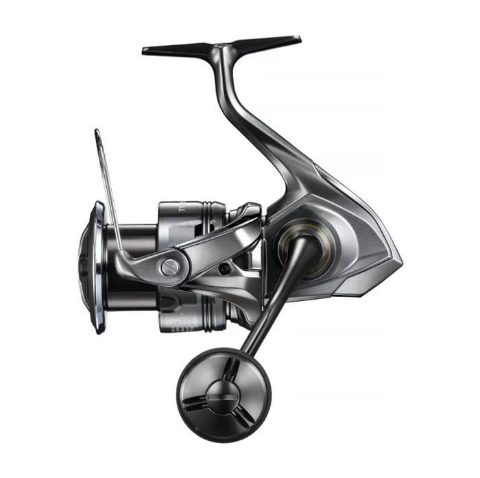 Side view of a silver Shimano 24ツインパワー C5000XG spinning fishing reel on a white background.