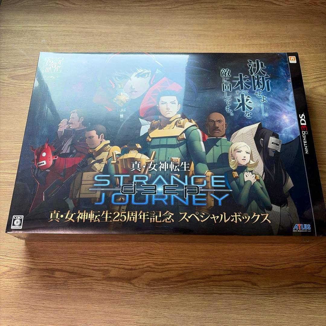 Front of the 25th anniversary special box for 真・女神転生 DEEP STRANGE JOURNEY (Nintendo 3DS) displayed on a wooden surface.