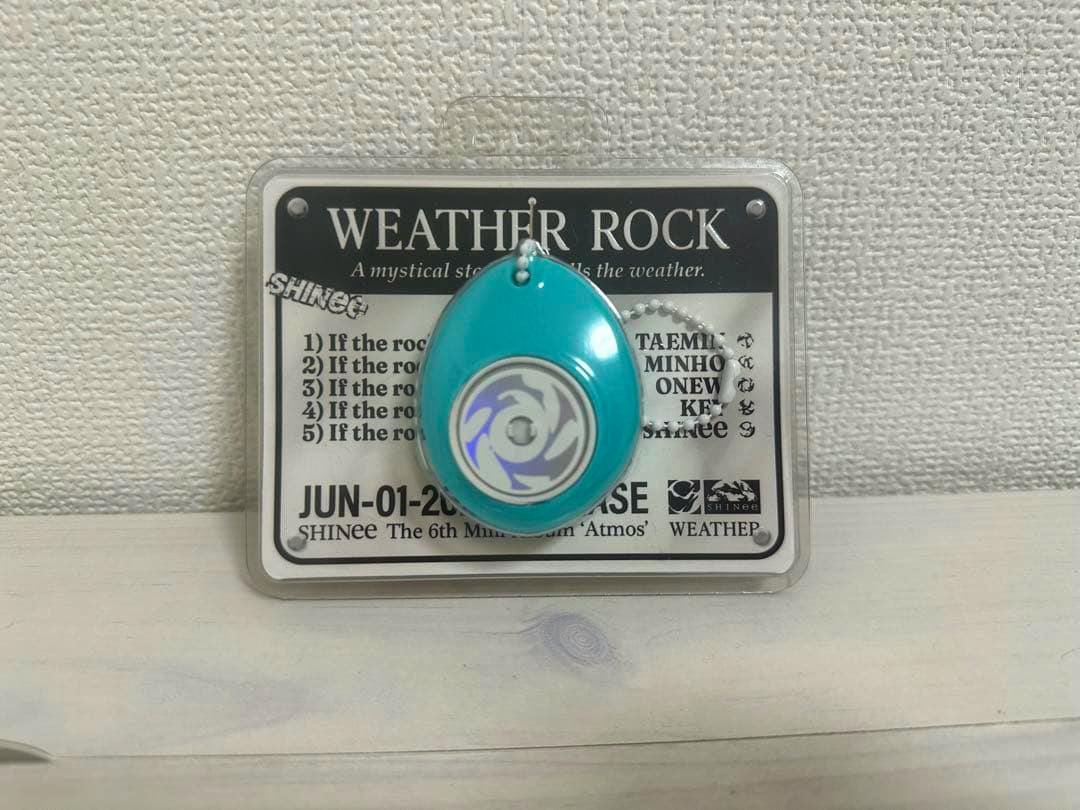 A teardrop-shaped turquoise Weather Rock keyring in its plastic packaging mounted on a backing card labeled "WEATHER ROCK".
