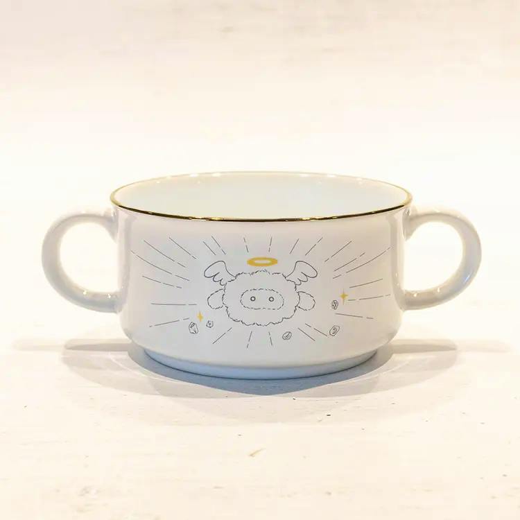 White ceramic two-handled soup cup (mug) with a gold rim and a small angel-like Pom character illustration on the front.