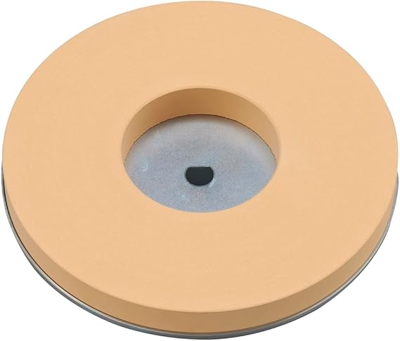 Round beige Shinko Seisakusho whetstone with a central circular hole and a visible metal hub.