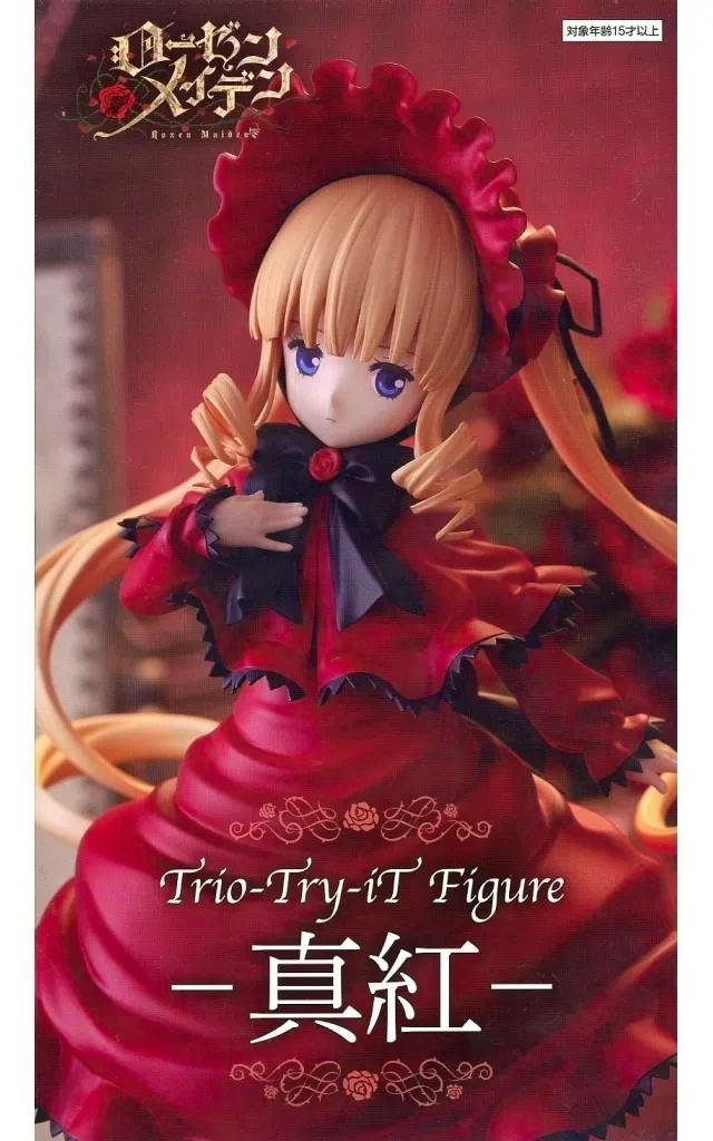 Close-up photo of the Shinku figure (Rozen Maiden) wearing a red dress and matching bonnet.