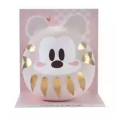 Front view of the Mickey daruma wooden figure on a pink background.