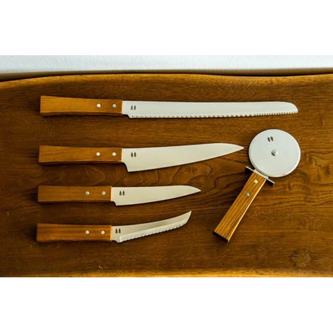 A wood-handled pizza cutter with a round metal blade displayed alongside four wooden-handled knives on a wooden board.