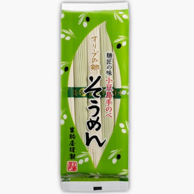 Front-facing photo of the packaged OS-65E 小豆島手延べオリーブの郷そうめん dried noodles in a green wrapper with Japanese text and olive motifs.