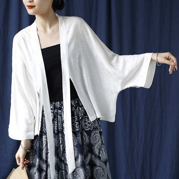 White women's kimono-style open-front blouse with long front ties worn by a model.