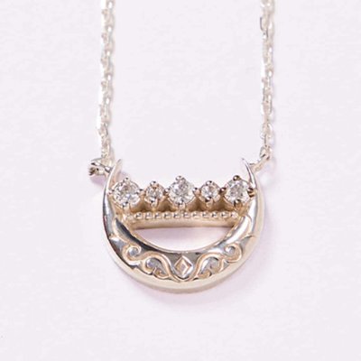 Silver necklace with a crescent-shaped pendant set with five small stones on a light background.