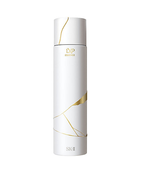 White cylindrical bottle of the LXP 金継ぎ エッセンス face serum with gold decorative lines and SK‑II branding.