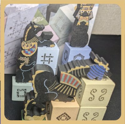 Photograph of wooden totem game pieces and numbered wooden blocks from the board game.