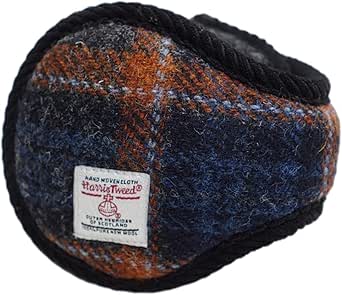 Close-up of a Harris Tweed ear muff in blue and brown plaid with a Harris Tweed label and black fluffy lining.
