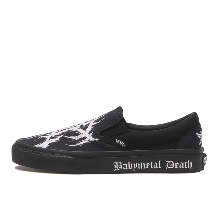 Black slip-on shoe with a white abstract print on the upper and "Babymetal Death" printed on the black midsole.