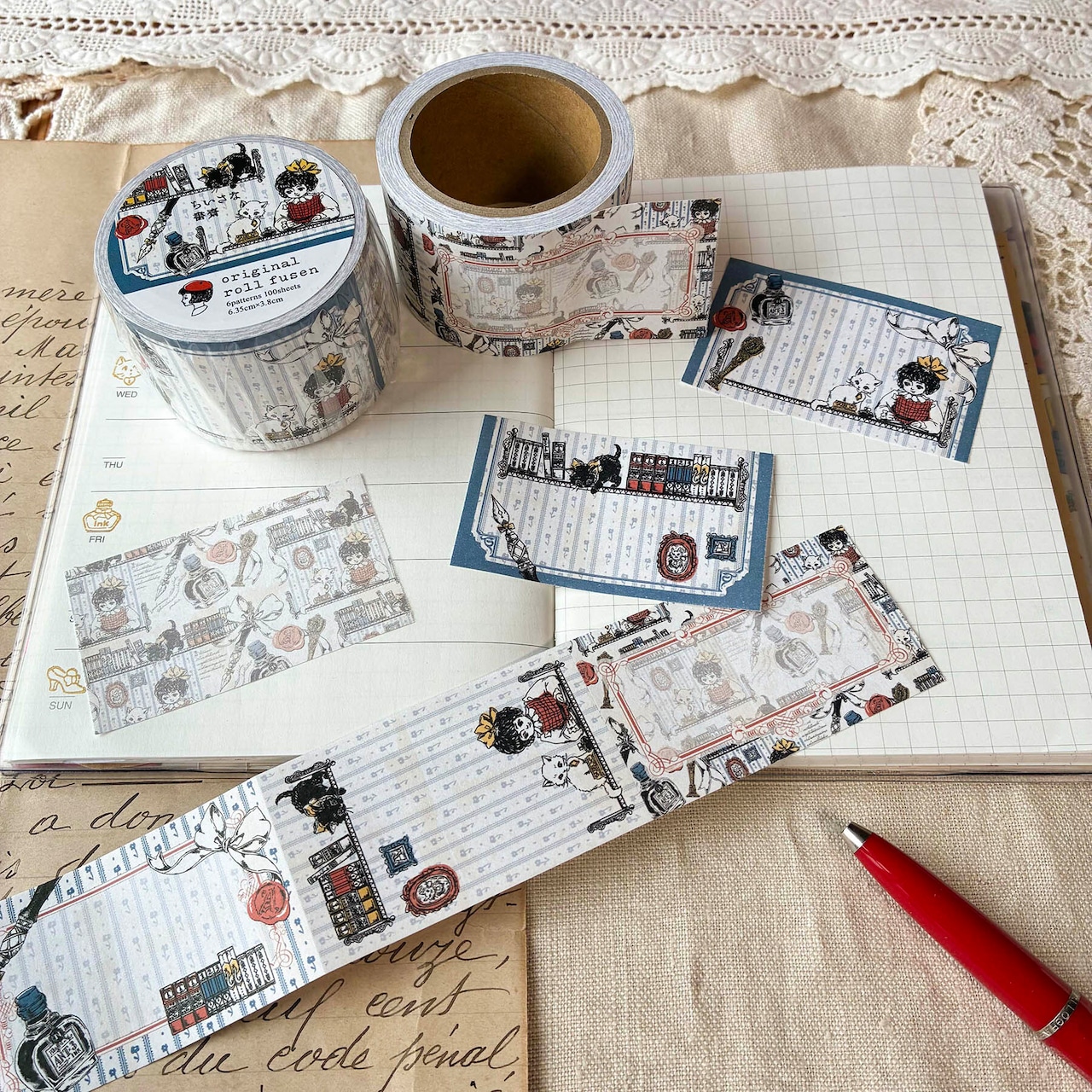 A roll of decorative roll sticky notes labeled “Small Study” with several torn note pieces displayed on an open notebook next to a red pen.