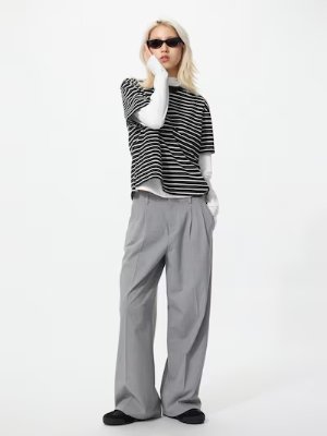 Model wearing gray wide straight women's pants shown full-length.