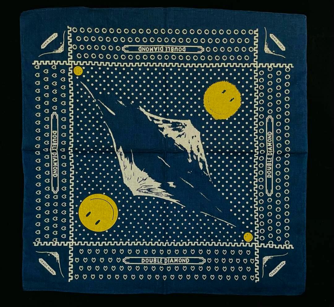 A blue cotton bandana showing a white Mount Fuji design with white dots and yellow smiley faces.