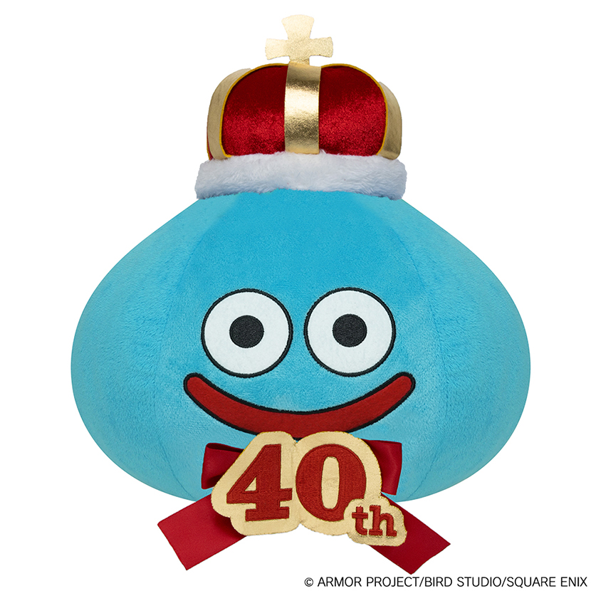 A blue Smile Slime plush toy wearing a gold-and-red crown and a "40th" anniversary ribbon on its front.