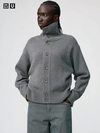 A model wearing the smooth cotton full-zip cardigan in gray, shown from the front with a high collar and ribbed hem.