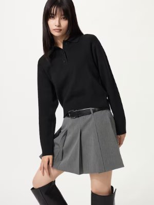 A model wearing a black polo-style cotton sweater with long sleeves and a collar.