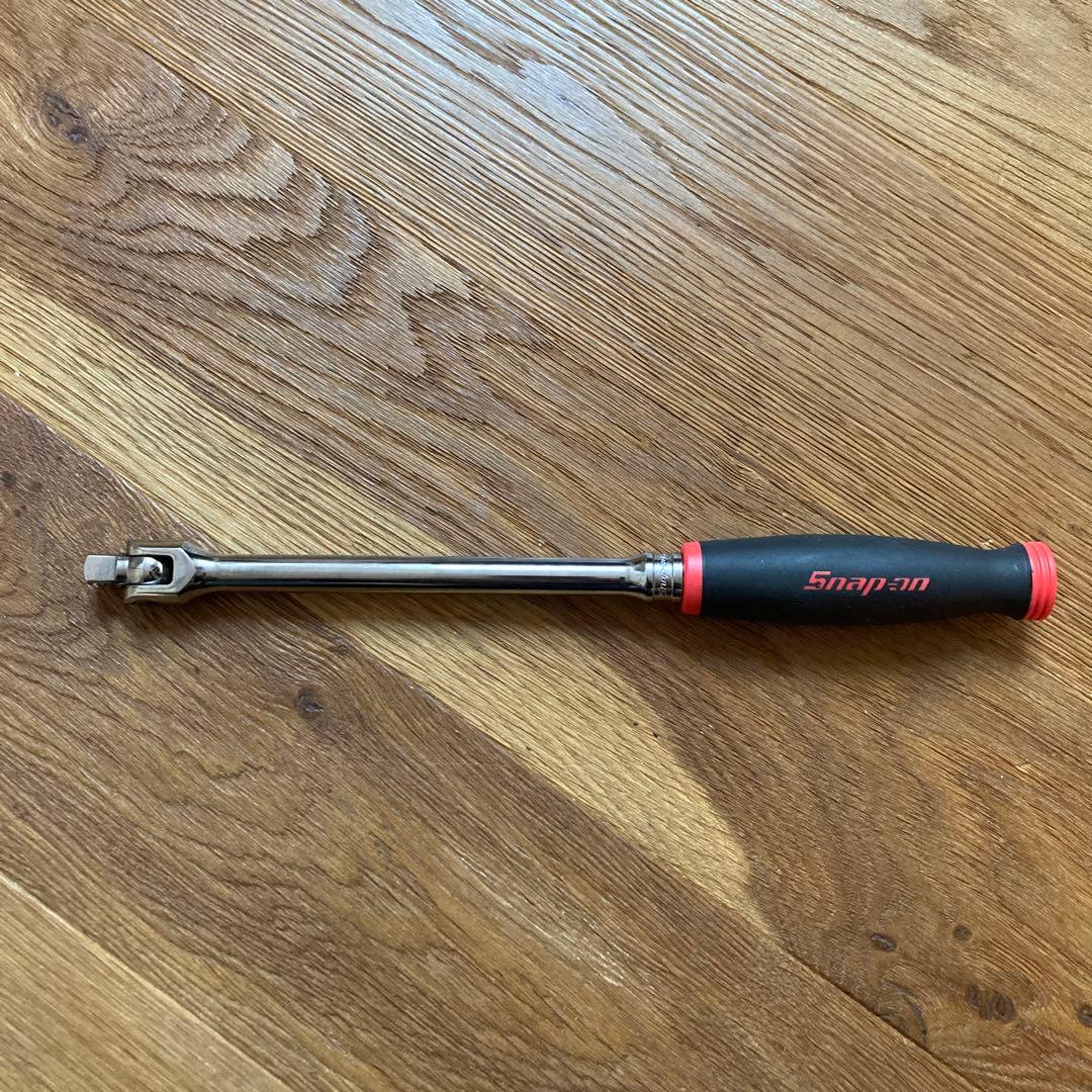 Snap-on 3/8 breaker bar spinner handle (FHBB12) laid flat on a wooden surface.